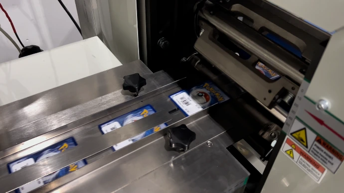 Trading cards being wrapped in clear roll stock film