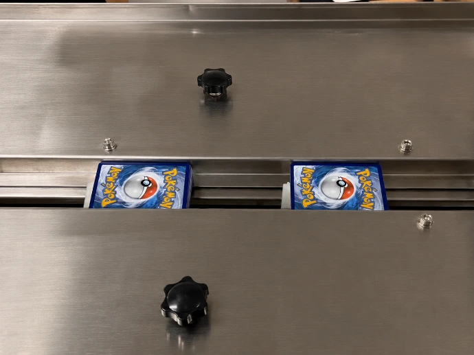 Stack of cards being fed into card packaging machine