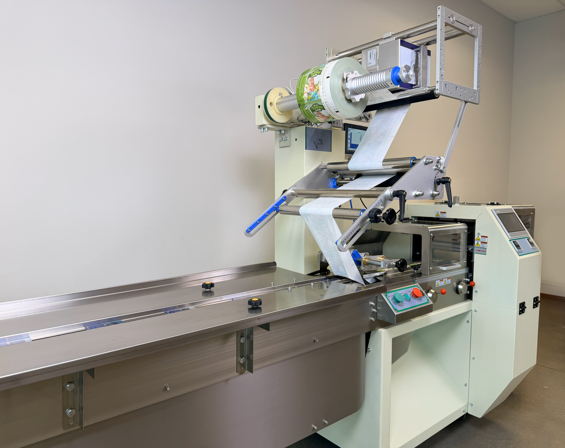 Automated card feeder and conveyor for flow wrapper packaging